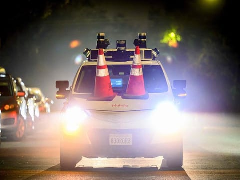 Members of SafeStreetRebel, a group of anonymous anti-car activists, placed traffic cones on a self-driving robotaxi to disable it in San Francisco, California.