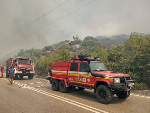 Firetrucks line up as firefighters try to extinguish a wildfire burning near Alaerma, Rhodes Island, Greece, July 22, 2023.