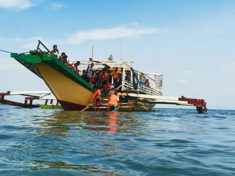 Rescued passengers arrive on a boat in Polillo, Quezon province, northeastern Philippines on Thursday Aug. 3, 2023.