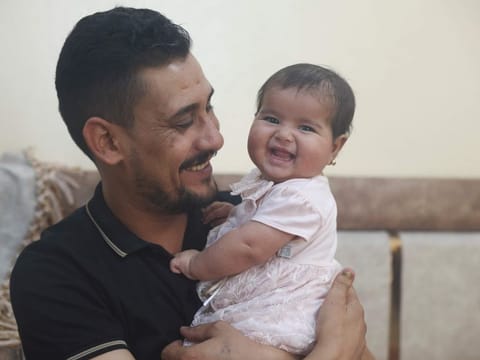 Khalil Al Sawadi with his adopted daughter Afraa in Jinderis, Syria, on August 5, 2023.