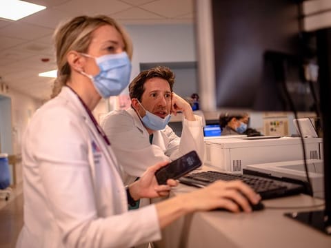 Critical care doctor at Mount Sinai Hospital Bojana Milekic and Matthew Levin look at patients who the AI program has predicted are the most at risk.