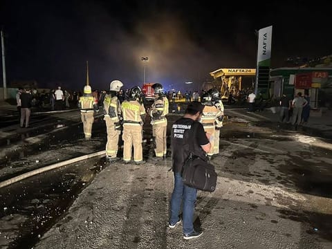 This handout photograph taken and released by Russian Investigative Committee on August 15, 2023, shows rescuers working at the site of a blast at a gas station in the city of Makhachkala.