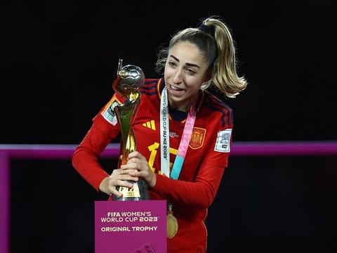 Spain's Olga Carmona celebrate with the trophy after winning the world cup
