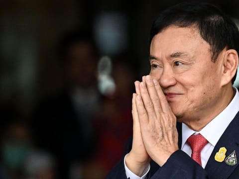 Former Thai Prime Minister Thaksin Shinawatra greets his supporters after landing at Bangkok's Don Mueang airport on August 22, 2023.