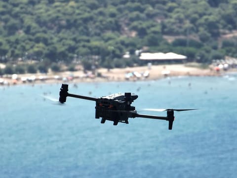 A long-range drone equipped with thermal imaging cameras and a sophisticated early warning system patrols over Kavouri beach and nearby woodland, in southern Athens, Greece.
