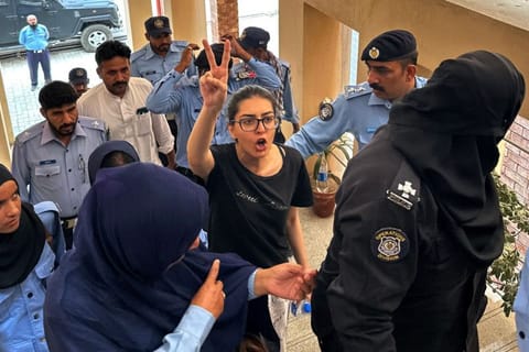 Police officials present arrested lawyer and human rights activist Imaan Mazari-Hazir (centre) before a court in Islamabad on August 20, 2023.