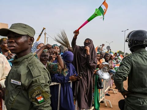 Nigerien Police officers stand guard as supporters of Niger's National Council of Safeguard of the Homeland (CNSP) protest outside the Niger and French airbase in Niamey on August 30, 2023 to demand the departure of the French troops from Niger.