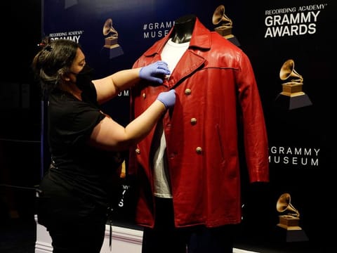 Collections assistant Cyrene Cruz primps a red leather jacket that was worn by the late rapper The Notorious B.I.G. in preparation for the exhibit 'Hip-Hop America: The Mixtape', at the Grammy Museum.