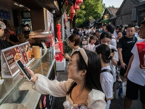 File photo: A young shopper at a snack stand in Nanluoguxiang in Beijing, China. Beijing has this week announced some of the strongest measures in years to boost activity in the world's second-largest economy