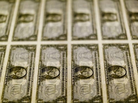 FILE PHOTO: U.S. dollar bills are seen on a light table at the Bureau of Engraving and Printing in Washington, November 14, 2014. REUTERS/Gary Cameron/File Photo