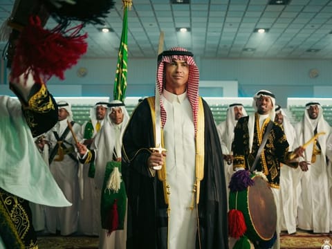 Al Nassr's Portuguese superstar Cristiano Ronaldo wears the traditional Saudi attire and holds a sword at his team's celebration of the kingdom's National Day last month.