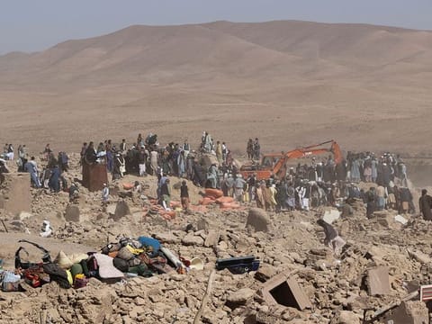 People search for survivors amidst the debris of a house that was destroyed by an earthquake in the district of Zendeh Jan, in Herat, Afghanistan.