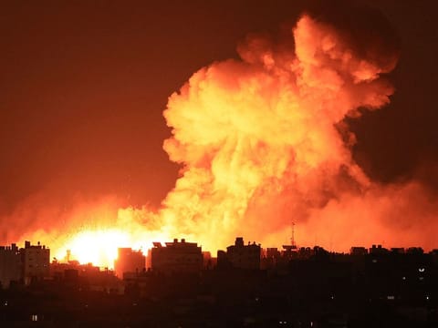 Explosions illuminate the sky during Israeli strikes on Gaza City on October 10, 2023. Israel said it recaptured Gaza border areas from Hamas as the war's death toll passed 3,000 on October 10, the fourth day of gruelling fighting since the Islamists launched a surprise attack.