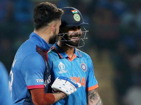 India's Virat Kohli and Afghanistan's Naveen-ul-Haq share a candid moment during their Cricket World Cup match, at Arun Jaitley Stadium in New Delhi on Wednesday.