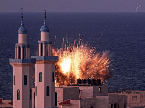 A fireball erupts from an Israeli airstrike in Gaza City on October 12, 2023.