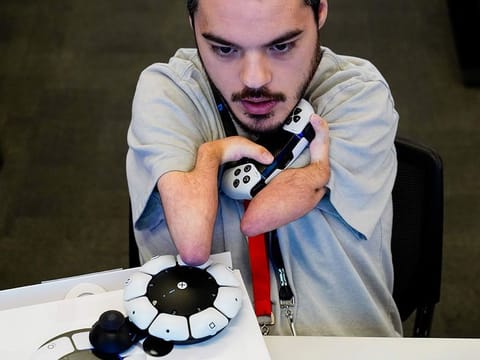 Martin Shane uses a Sony Access controller, left, to play a video game at Sony Interactive Entertainment headquarters