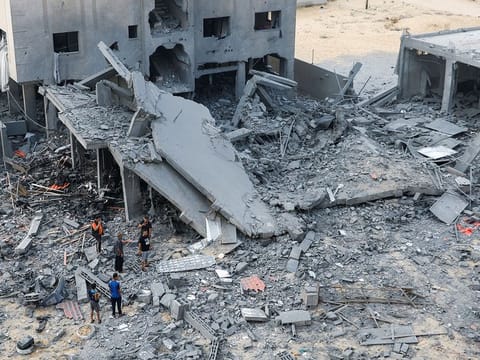 Palestinians inspect the site of Israeli strikes on a house in Khan Younis in the southern Gaza Strip.