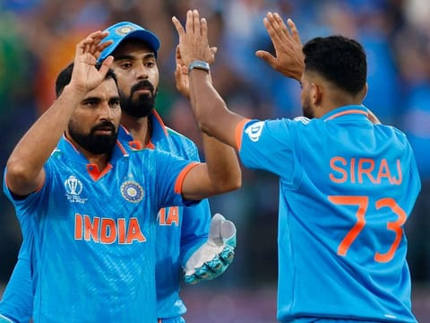 India’s Mohammed Shami celebrates with Mohammad Siraj and KL Rahul after taking the wicket of New Zealand’s Rachin Ravindra in the ICC Cricket World Cup 2023 match at the Himachal Pradesh Cricket Association Stadium, Dharamsala, India, on October 22, 2023. Shami claimed a five-wicket haul that prevented a late assault by Kiwi batters.