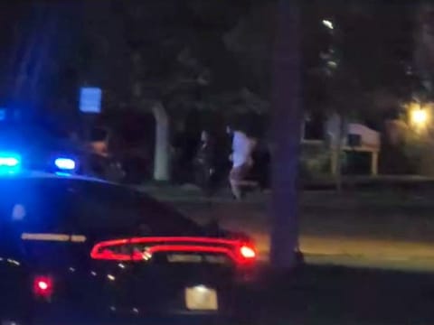 People run from the scene of a mass shooting in Lewiston, Maine.