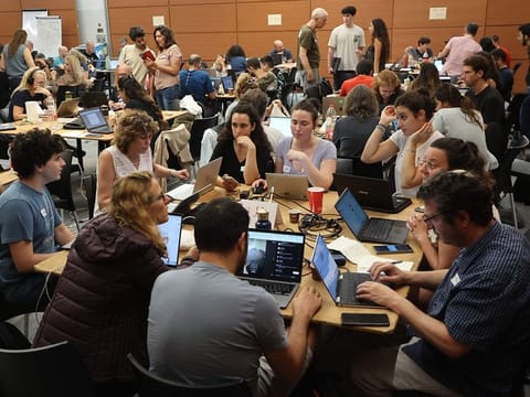 Volunteers take part in a taskforce in Tel Aviv to identify missing persons in the aftermath of a surprise attack by Hamas.