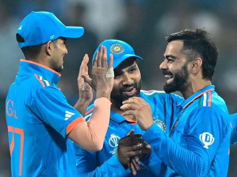 India’s Virat Kohli (right) celebrates with Shubman Gill (left) and captain Rohit Sharma after taking the wicket of Netherlands’ captain Scott Edwards during the 2023 ICC Men's Cricket World Cup match at the M. Chinnaswamy Stadium in Bengaluru on November 12, 2023. India won to extend their win streak to nine matches. They will meet New Zealand in the semifinals on November 15, 2023.
