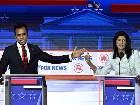 Entrepreneur and author Vivek Ramaswamy and former Governor from South Carolina and UN ambassador Nikki Haley gesture as they speak during a Republican Presidential primary debate