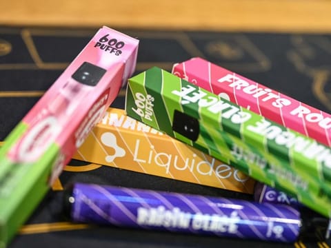 Disposable electronic cigarettes displayed on table at La Vapotitheque store in Bethune, northern France.