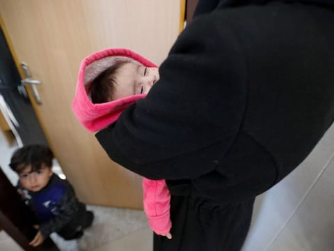 Palestinian children wait to get examined by a doctor, amid a warning by World Health Organisation of a surge in infectious diseases and diarrhoea in children, at a healthcare centre in Khan Younis.