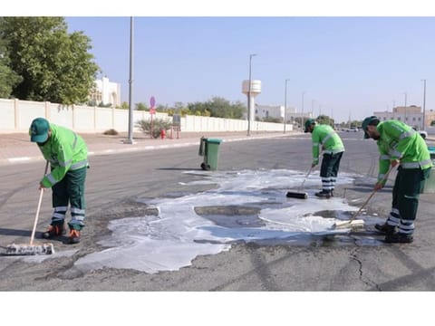 The trio washing a road as part of the community service ordered by the court.