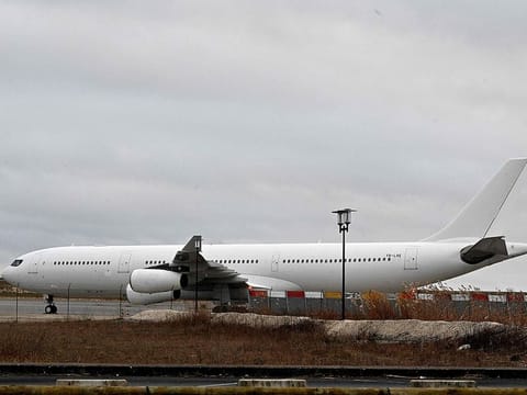 This photograph taken on December 23, 2023, shows the Airbus A340 which was grounded over suspected "human trafficking" at Vatry airport, north-eastern France. The Airbus A340 has been held at Vatry airport, 150 kilometres (95 miles) east of Paris, following an anonymous tip-off that it was carrying potential victims of human trafficking. Thirteen unaccompanied minors are among the more than 300 Indian passengers.