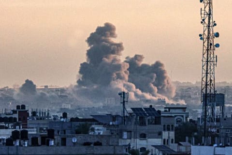 Smoke billows over Khan Younis in the southern Gaza Strip during Israeli bombardment, as the war between Israel and the Palestinian militant group Hamas enters its 100th day on January 14, 2024.