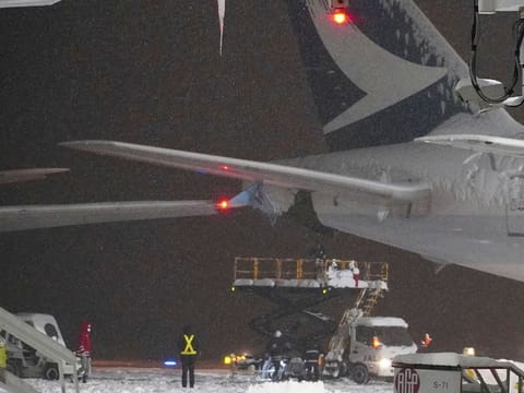 A Korean Air plane carrying 289 people hit a parked Cathay Pacific aircraft while being pushed by a ground vehicle ahead of takeoff at northern Japan's New Chitose Airport on Tuesday but caused no fire or injuries, fire and airline officials said.