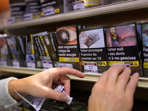A tobacconist changes tobacco price labels in a shop in Hede-Bazouges, western France.