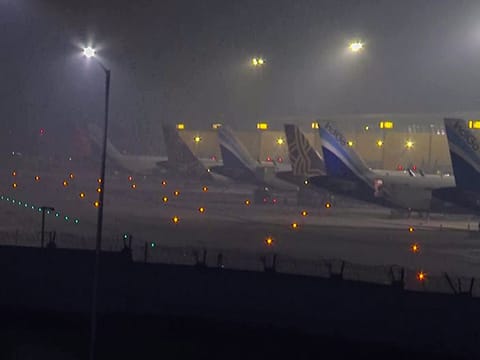 Heavy fog blankets the Indira Gandhi International Airport on a chilly winter morning in New Delhi. Numerous flights are facing delays, with some even canceled, owing to widespread fog across various parts of India.