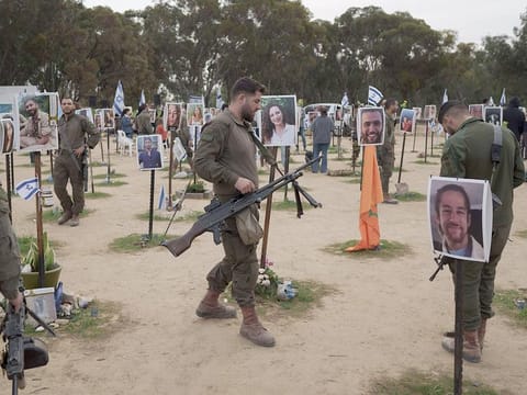 Israeli soldiers visit the site where revellers were killed on October 7 in a cross-border attack by Hamas at the Nova music festival in Re'im, Southern Israel, on Sunday, January 21, 2024, during an event where friends and relatives are planting trees in memory of their loved ones.
