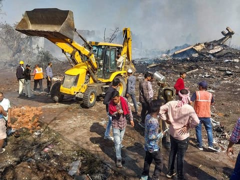 Rescue personnel and local residents gather near a firecracker plant following an explosion at Harda district in India's Madhya Pradesh state on February 6, 2024.