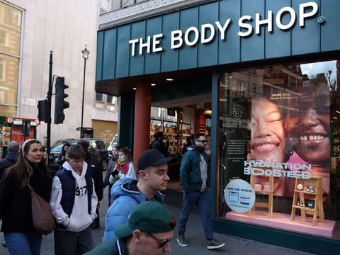 Pedestrians walk bas a branch of The Body Shop in central London on February 12, 2024. The Body Shop, the near 50-year-old cosmetics company renowned for its ethical hair and skin products, is near bankrupt in the UK after poor Christmas trade, according to reports in British media.