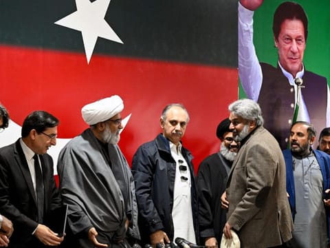 Omar Ayub Khan (4rth left), nominee for prime minister from Pakistan Tehreek-e-Insaaf (PTI) party, Gohar Ali Khan (second left) PTI's chairman and barrister speak with Sahibzada Muhammad Hamid Raza (third right), leader of the political group Sunni Ittehad Council during press conference following their coalition in Islamabad on February 19, 2024.