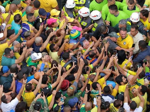 Brazil's former president Jair Bolsonaro leaves while his supporters gather on Paulista Avenue, as police investigate him and his cabinet for allegedly plotting a coup after the 2022 election, in Sao Paulo, Brazil, February 25, 2024.
