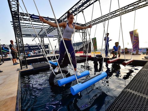 File picture of participants trying their hands at the Iron Grip obstacle during a media preview of a previous edition of Government Games at Kite Beach in Dubai