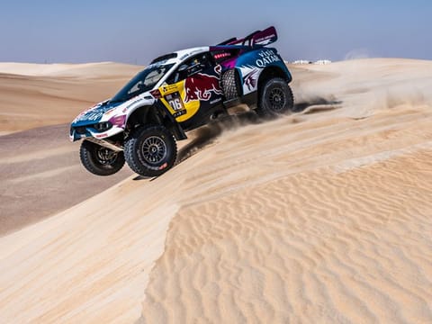 Nasser Al Attiyah tackling a dune during the challenging stage in the Abu Dhabi Desert Challenge on Tuesday.