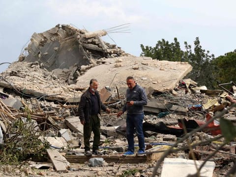Men check the site of an Israeli air strike that targeted a house in the southern Lebanese village of Jibshit on February 27, 2024. Since October 8, following the Hamas attack on southern Israel and the start of Israel's relentles bombardment of the Gaza Strip, Hezbollah and its arch-foe neighbour have exchanged near-daily fire, but strikes have been largely contained to the border between the two countries -- although Israel has on occasion launched strikes elsewhere in Lebanon, including in Beirut.