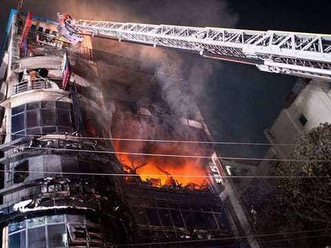 Firefighters work to contain a fire that broke out at a commercial complex in Dhaka, Bangladesh, Thursday, Feb. 29, 2024. Bangladesh's health minister says a fire in a six-story commercial complex in the nation's capital, Dhaka, has killed several people and injured dozens of others