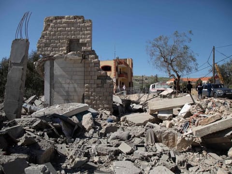People inspect the site of an Israeli airstrike a day earlier in the southern Lebanese village of Odaisseh near the border with Israel on March 5, 2024.