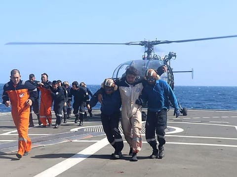 This handout photograph shows the rescue operation of crew members of a Barbados-flagged bulk carrier by Indian Navy after an attack by Yemen's Houthi militants, in the Gulf of Aden.