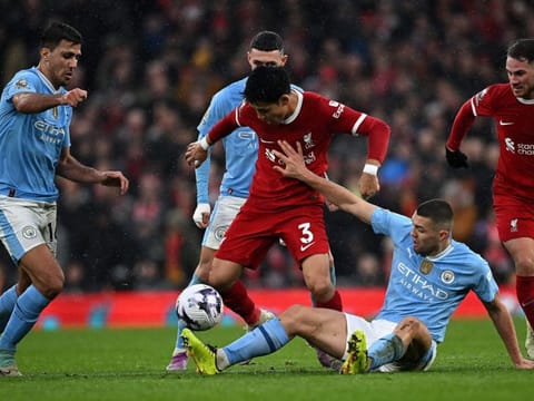 Manchester City's midfielder Mateo Kovacic vies with Liverpool's midfielder Wataru Endo during the English Premier League football match at Anfield in Liverpool on Sunday.