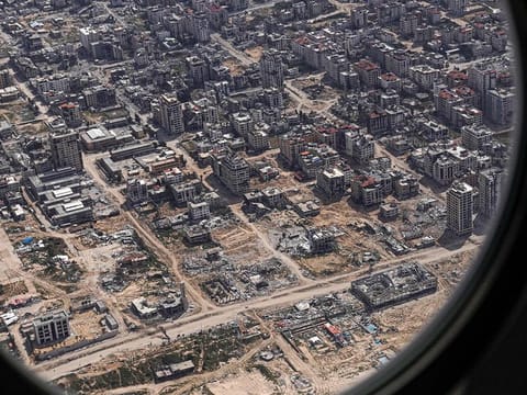 A partial view of the Gaza Strip appears from the porthole of the US Air Force 26th Expeditionary Rescue Squadron HC-130J aircraft during an airdrop mission of humanitarian aid supplied by Jordan, on March 14, 2024, amid the ongoing conflict between Israel and the Palestinian Hamas movement.