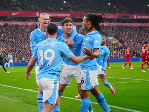Manchester City players celebrate after scoring the opening goal during their English Premier League match against Liverpool.