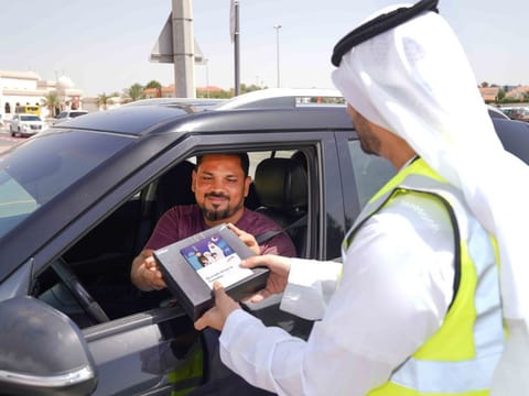 A staff of the Dubai Roads and Transport Authority (RTA) talks to a motorist in Dubai. The authority launched numerous awareness activities for the month of Ramadan, urging drivers to observe traffic laws and respecting other road users’ rights.