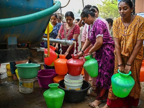 Residents collect free water from a municipal tanker amidst the ongoing water crisis in Bengaluru on March 15, 2024.